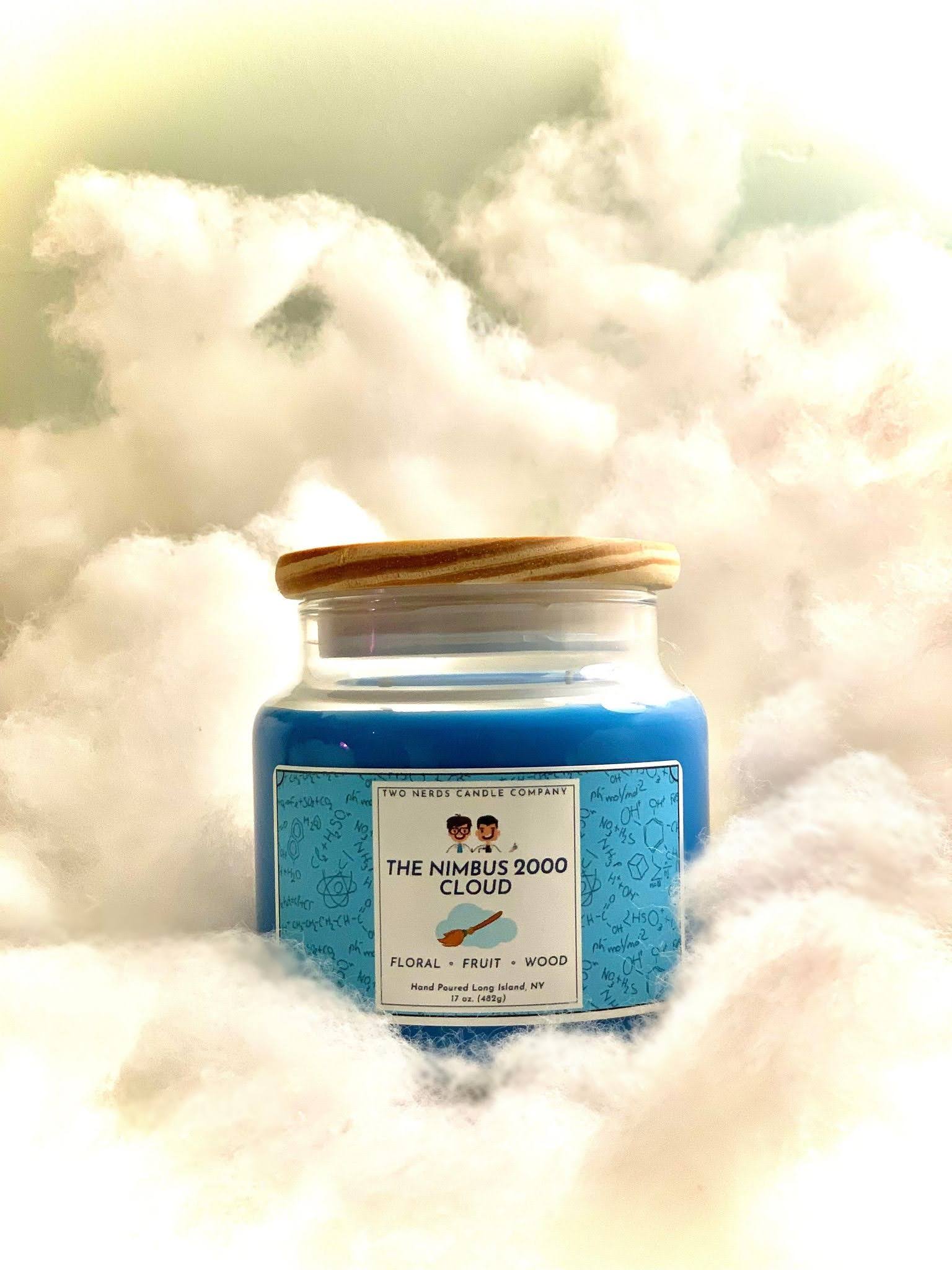 A soy candle on a cloud background with a Harry Potter theme. This candle is based around the Nimbus 2000 broomstick.