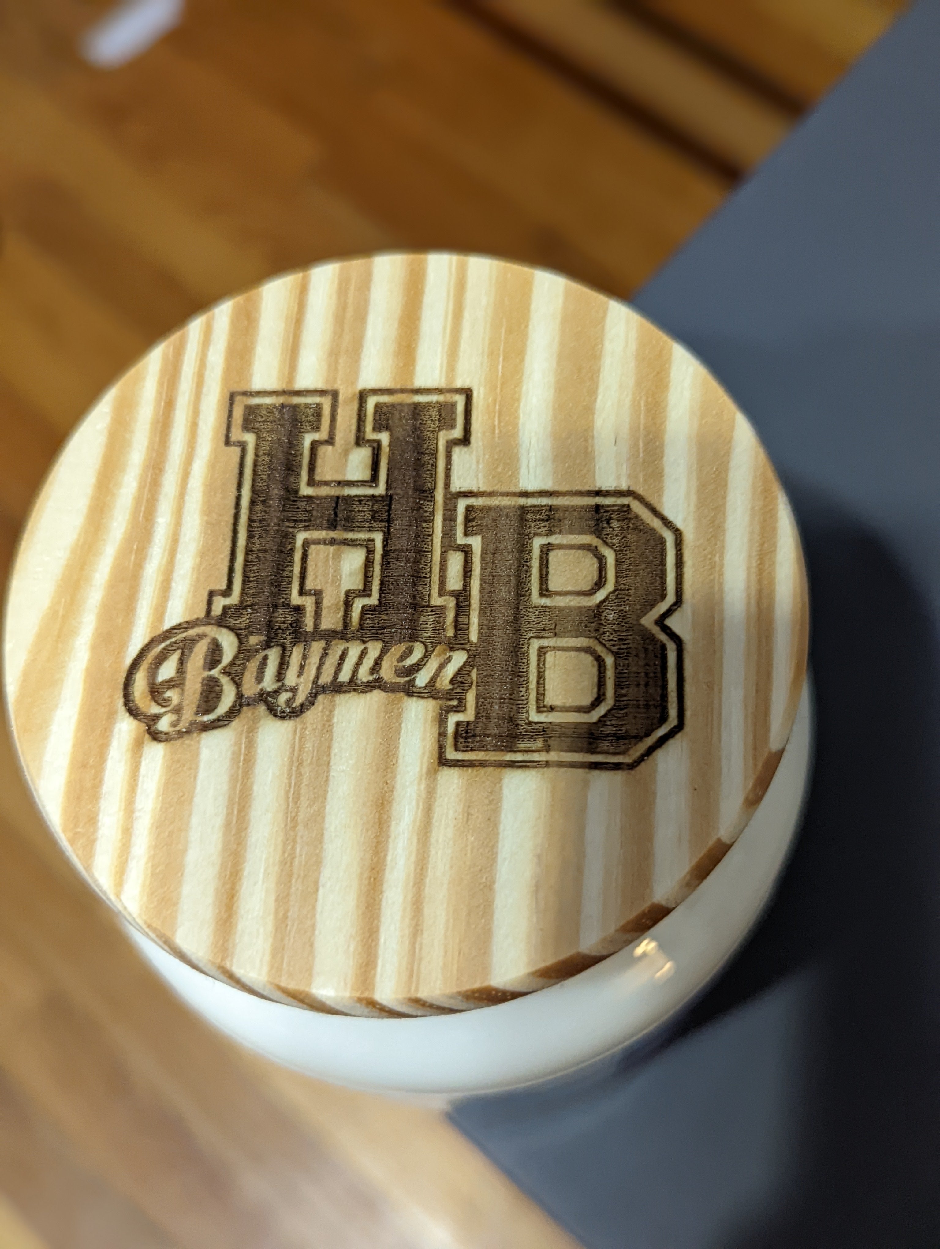 This is a custom branded candle lid for the Hampton Bays school. It has the school logo engraved in the lid.