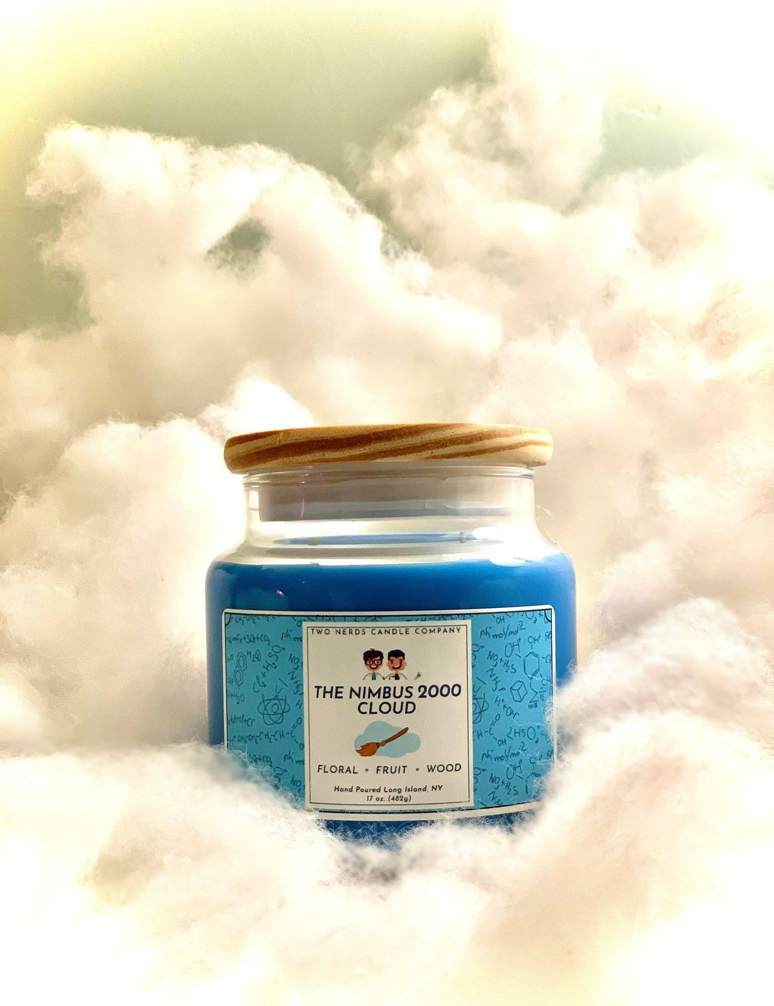 A soy candle on a cloud background with a Harry Potter theme. This candle is based around the Nimbus 2000 broomstick.
